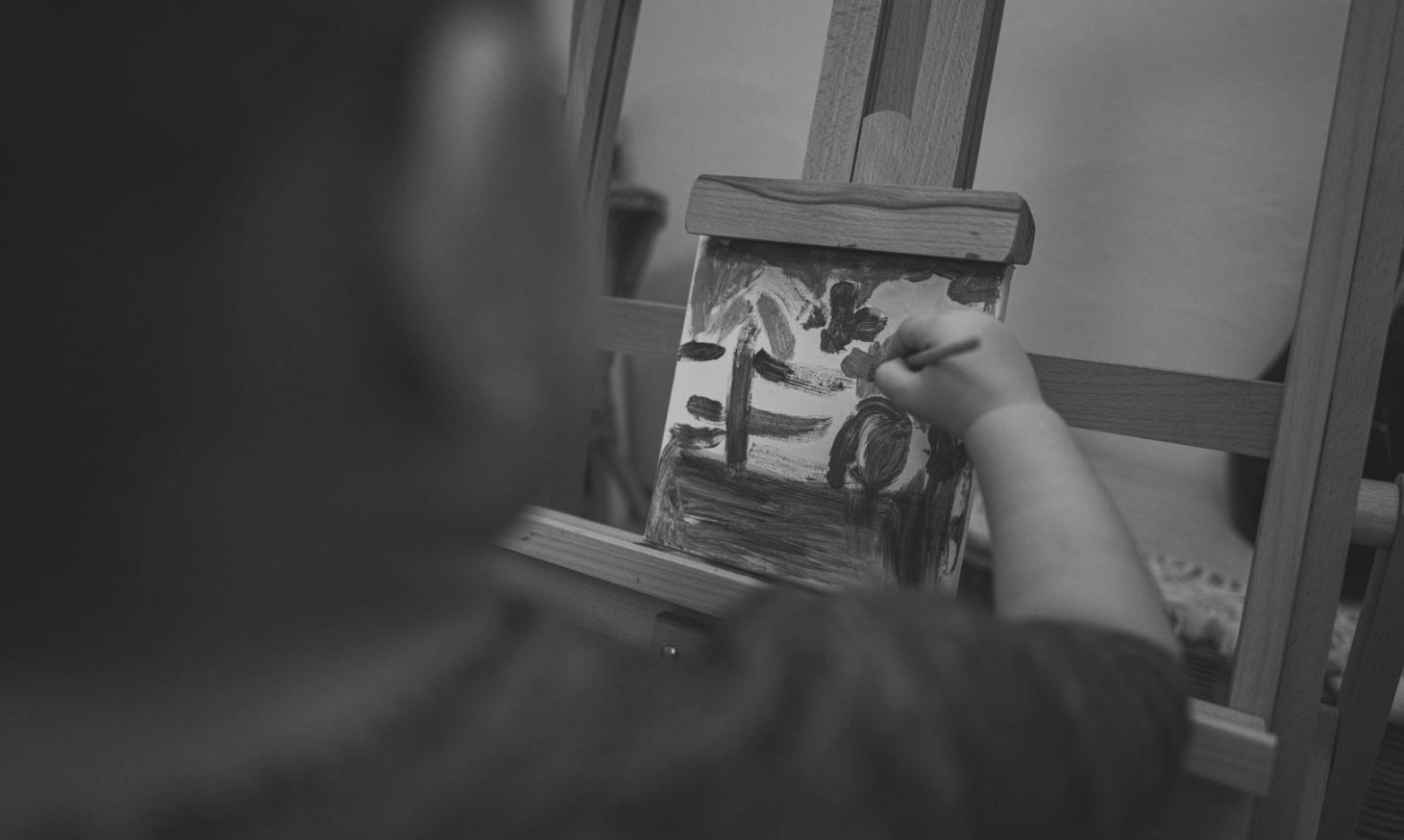 Künstler beim Arbeiten an detaillierter Zeichnung in hellem Atelier